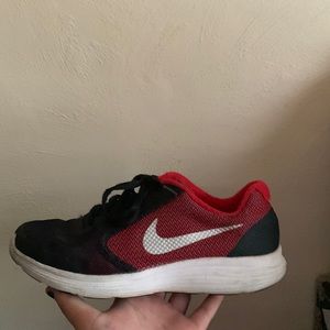 Boy tennis shoe, worn but not in bad condition.